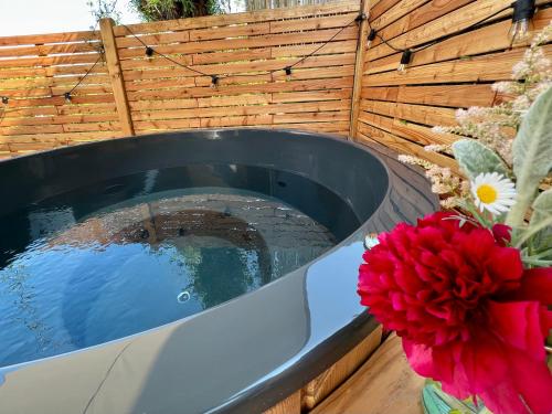 a plunge pool in a garden with flowers next to it at Tiny House Gänseblümchen in Kirchanschöring