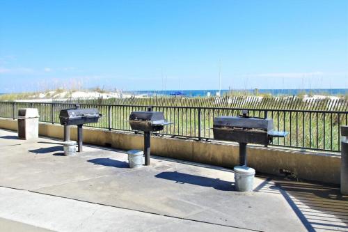 a row of parking meters in front of a fence at Phoenix 5 Unit 1504 in Orange Beach