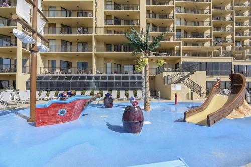 a swimming pool with a playground in a resort at Phoenix 5 Unit 1504 in Orange Beach