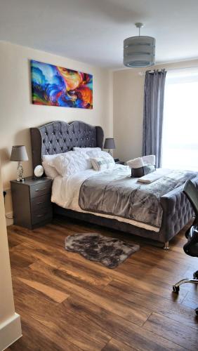 a bedroom with a large bed and a large window at Keniji Luxury 2 Bed Apartment in Milton Keynes