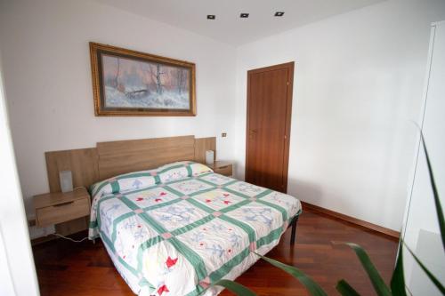 - une chambre avec un lit et une photo sur le mur dans l'établissement Appartamento del sole, à San Benedetto del Tronto
