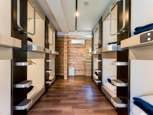 a hallway with bunk beds in a room at Yuraku Izu-Oshima dormitory - Vacation STAY 51863v in Oshima