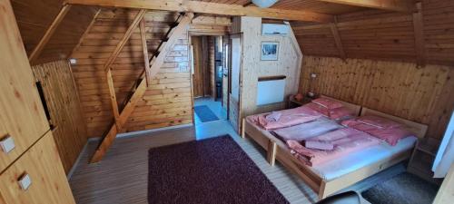 an overhead view of a bedroom in a wooden cabin at Kéri Apartman in Mosonmagyaróvár