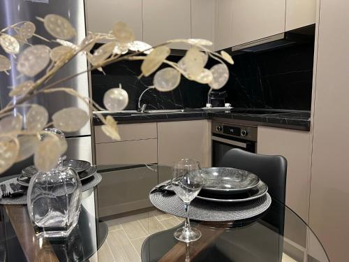 a kitchen with a table with wine glasses on it at Urban Gem by Homebrain in Alexandroupoli