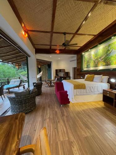 a bedroom with a bed and a living room at Villa Lala Boutique Hotel Adults Only in Puerto Vallarta