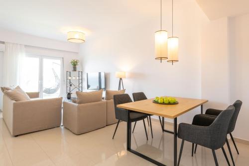 a dining room and living room with a table and chairs at Island Hills in Rhodes Town