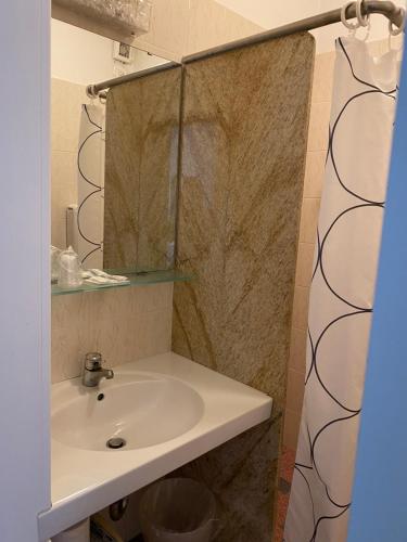 a bathroom with a sink and a mirror at Hotel La Perla in Riva del Garda