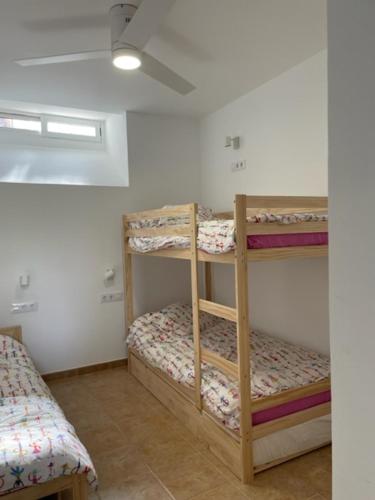 a room with three bunk beds in a room at PISO CON TERRAZA EN NAVAJAS in Navajas