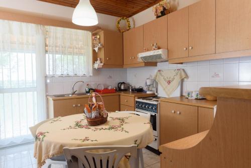 a kitchen with a table with a basket on it at Helen's house in Igoumenitsa