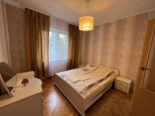 a small bedroom with a bed and a window at AGA in Augustów