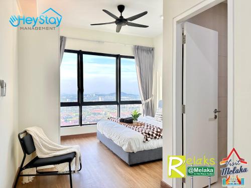 a bedroom with a bed and a ceiling fan at The Apple Residence By Heystay Management in Melaka