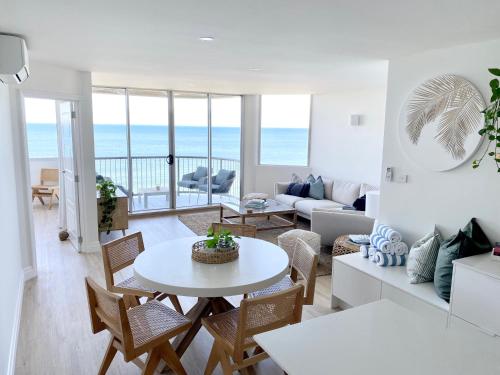 a living room with a table and chairs at Monterey Lodge - Unit 18, 27 Warne Terrace, Kings Beach Caloundra in Caloundra