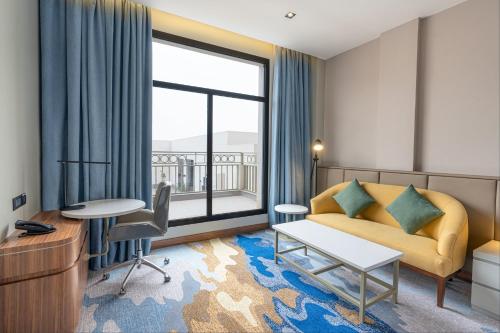 a living room with a couch and a large window at Holiday Inn Riyadh The Business District by IHG in Riyadh