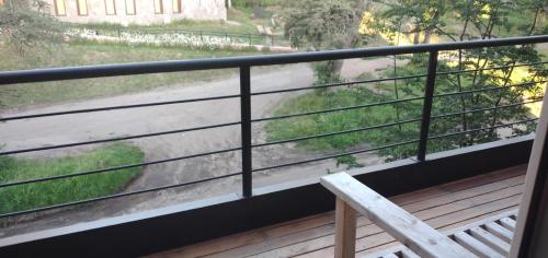 a balcony with a bench and a view of a street at DEPARTAMENTO HOPE 2 in Villa La Angostura