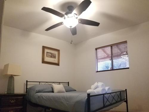 a bedroom with a ceiling fan and a bed at Lake Isabella View, Wofford Heights, Kern County in Wofford Heights