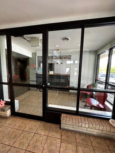 a room with glass doors and a red chair at Valued Stay Aloha in Madison