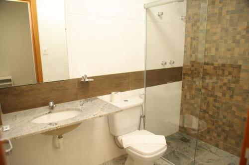 a bathroom with a toilet and a sink and a shower at Rede Andrade Pampulha in Belo Horizonte