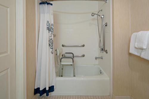 a bathroom with a shower and a bath tub at Residence Inn by Marriott Oxnard River Ridge in Oxnard