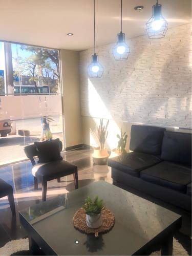 a living room with a couch and a table at Hotel La Terminal in San Miguel de Tucumán