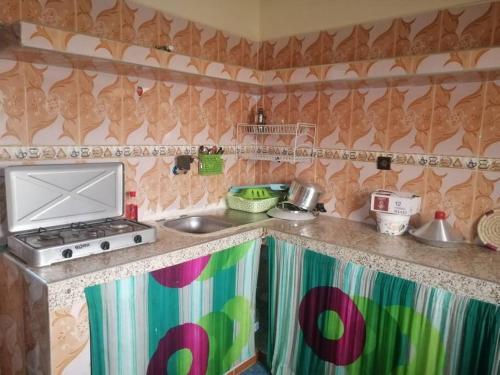 a kitchen with a sink and a stove top oven at Modern flat Dakhla in Dakhla
