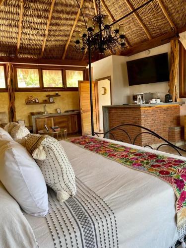 a bedroom with a bed with a television in it at Casa Miura Hotel Boutique in Ajijic