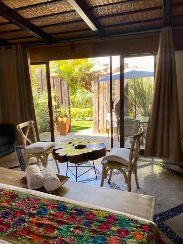 a room with a bed and a table and chairs at Casa Miura Hotel Boutique in Ajijic