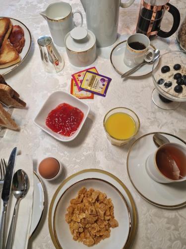 a table with plates of food and cups of coffee at Divine Cottage in Ballycastle