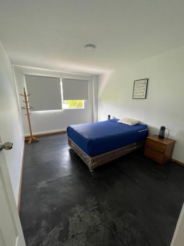 1 dormitorio con cama y ventana en condominio haras de lurin, en Lurín
