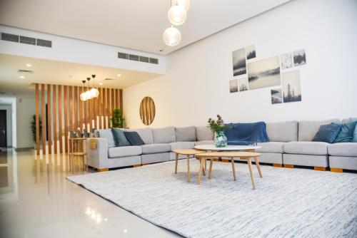 a living room with a couch and a table at Seascape Villa in Fujairah