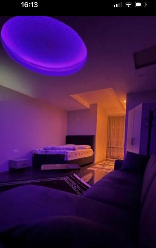 a purple room with a bed and a purple ceiling at Das Suit in Pazar