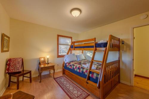 a bedroom with a bunk bed and a chair at Londonos Paradise in Beech Mountain