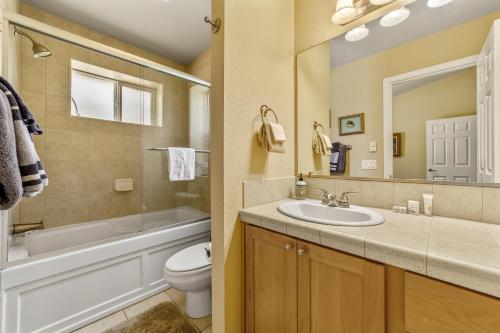 a bathroom with a sink and a tub and a toilet at Ocean Lover's Landing in Gold Beach