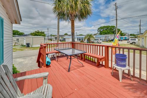 a table and two benches on a wooden deck at Walk to Shore Myrtle Beach House with Private Deck! in Myrtle Beach