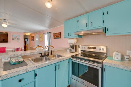 a kitchen with blue cabinets and a sink at Walk to Shore Myrtle Beach House with Private Deck! in Myrtle Beach