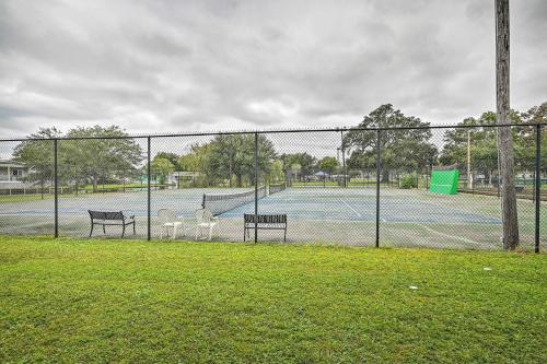 a tennis court with two benches and a fence at Walk to Shore Myrtle Beach House with Private Deck! in Myrtle Beach