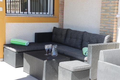 a living room with a couch and a table at Cozy Villa in Campasol with private pool in Mazarrón
