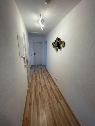 a hallway with white walls and a wooden floor at Ferienwohnung Marie in Rüdesheim am Rhein