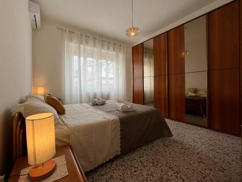 a bedroom with a bed and a large window at Appartamento Nautes in San Benedetto del Tronto
