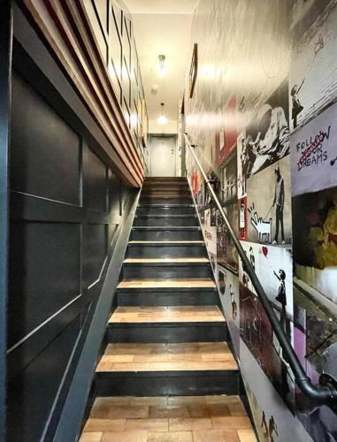 a long hallway with stairs in a building at Duplex Apartment Harbourside city centre in Bristol