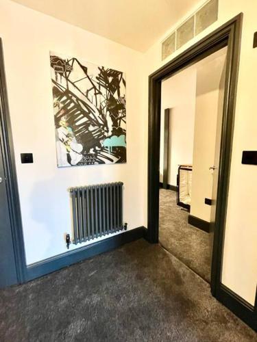 a hallway with a door leading into a room at Duplex Apartment Harbourside city centre in Bristol