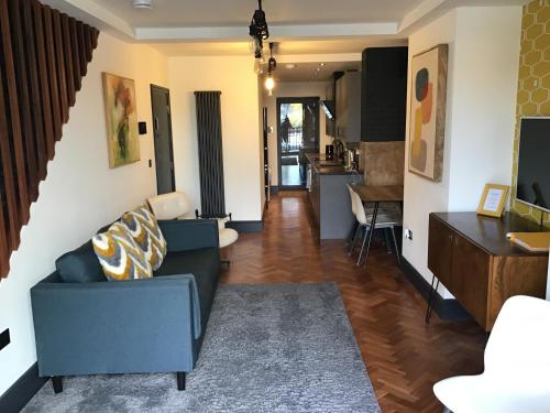 a living room with a couch and a dining room at Duplex Apartment Harbourside city centre in Bristol