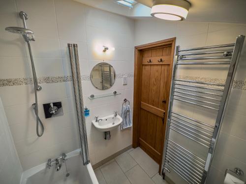 a bathroom with a shower and a sink at All Seasons Cottage Breaks in Saxmundham