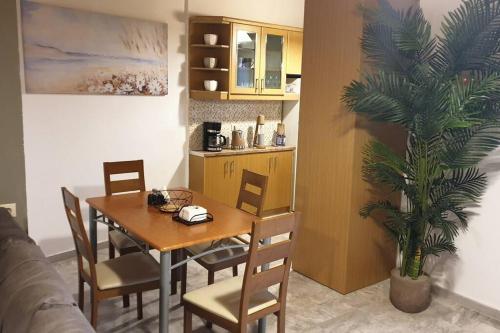 a dining room with a table and chairs and a plant at Pure Blue House in Athanion