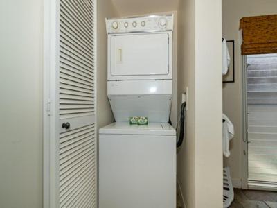 a kitchen with a white refrigerator and a microwave at Aina Nalu Lahaina in Lahaina