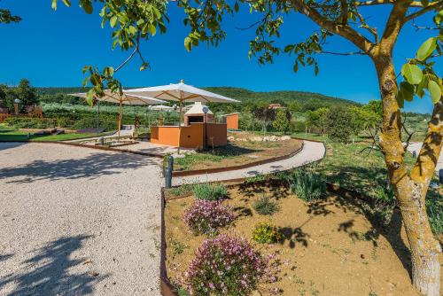 a park with a tree and a pavilion at Relais Paradiso Resort & Spa in Gualdo Cattaneo