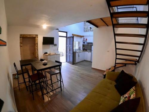a living room and kitchen with a couch and a table at Vecchio Loft in Siracusa