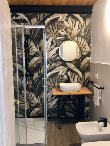 a bathroom with a sink and a mirror at Vecchio Loft in Siracusa