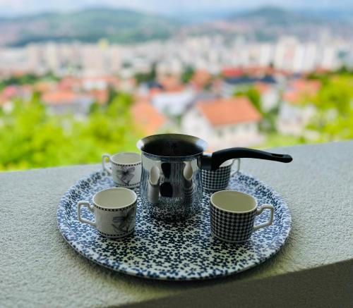 a tray with three coffee cups on a table at The View Apartment Sarajevo in Sarajevo