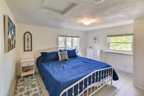 a bedroom with a blue bed and two windows at Pet-Friendly Upstate NY Home Less Than 1 Mi to Cayuga Lake in Aurora