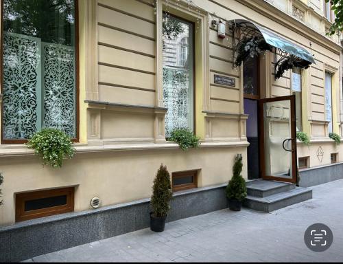 a building with potted plants on the side of it at Family Residence Boutique Hotel in Lviv